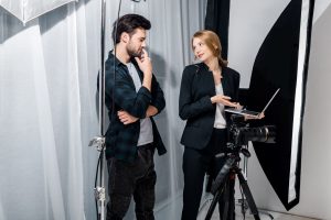 photographer and model using laptop and smiling ea 2023 11 27 05 28 12 utc
